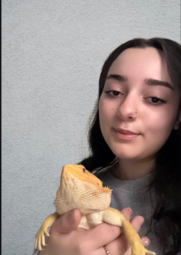 Sarah, co-founder of Beardie Supply Co., holding her bearded dragon